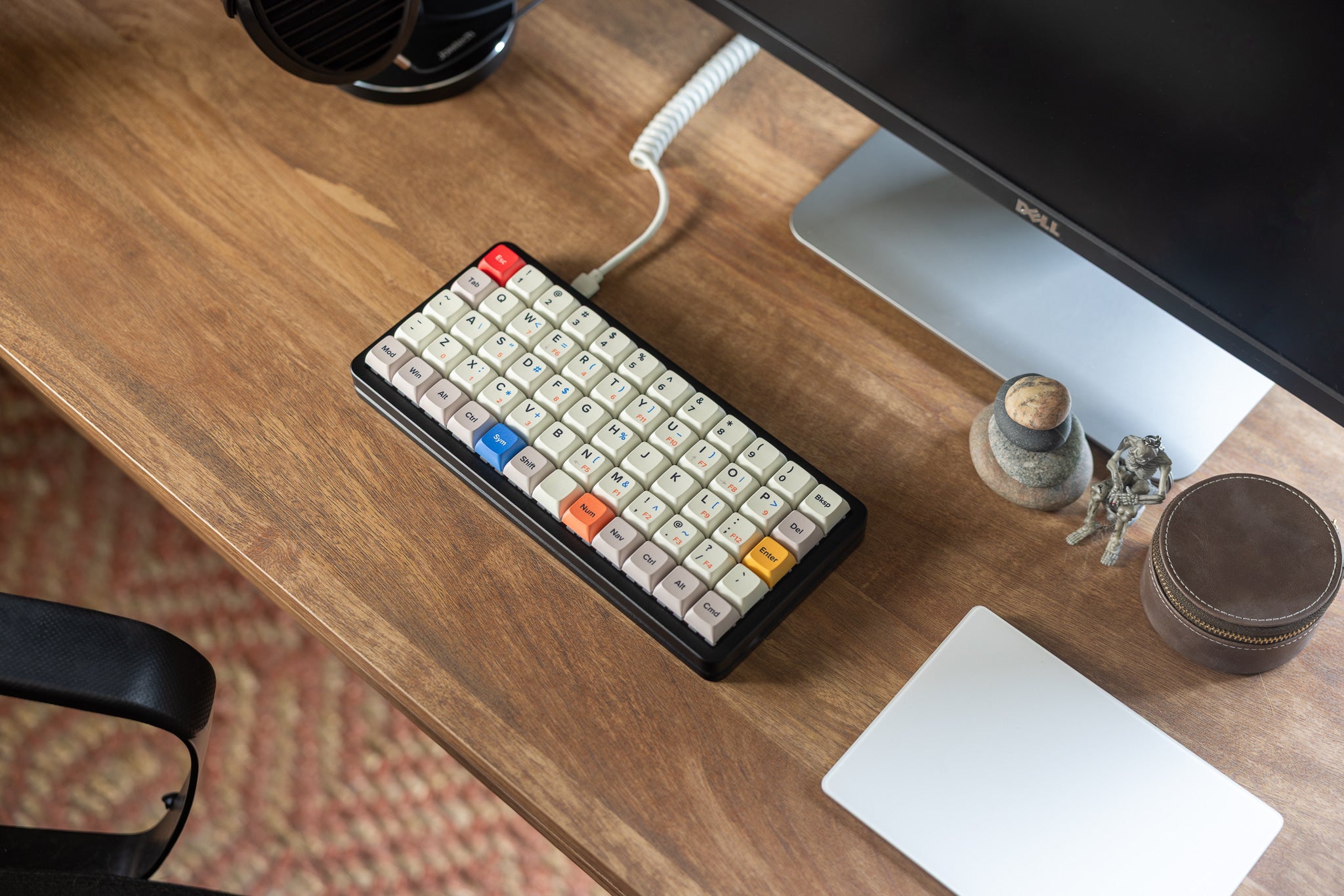 Preonic Rev 4 on a wooden desk beside a monitor and a pair of headphones