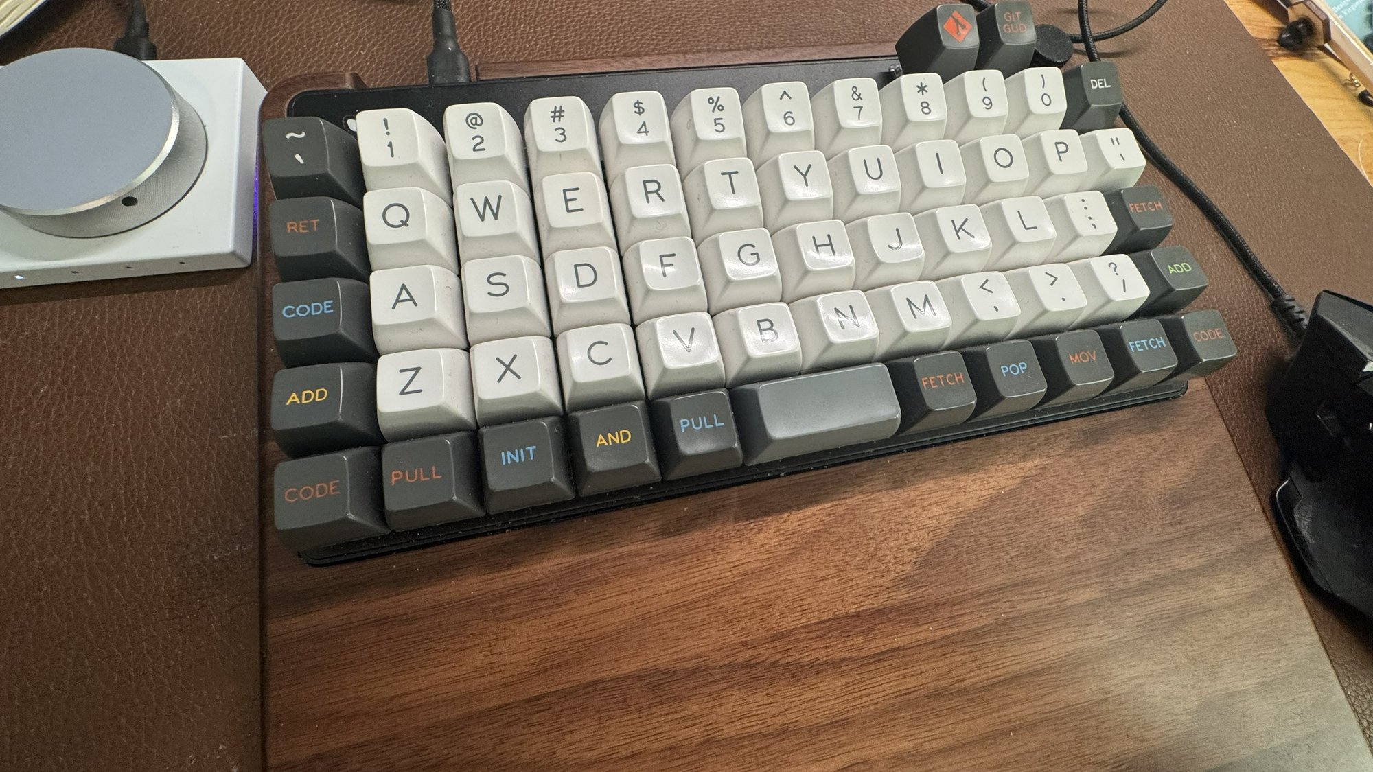 Our Keyboardio Preonic with SA Oblivion keycaps on the walnut wrist rest